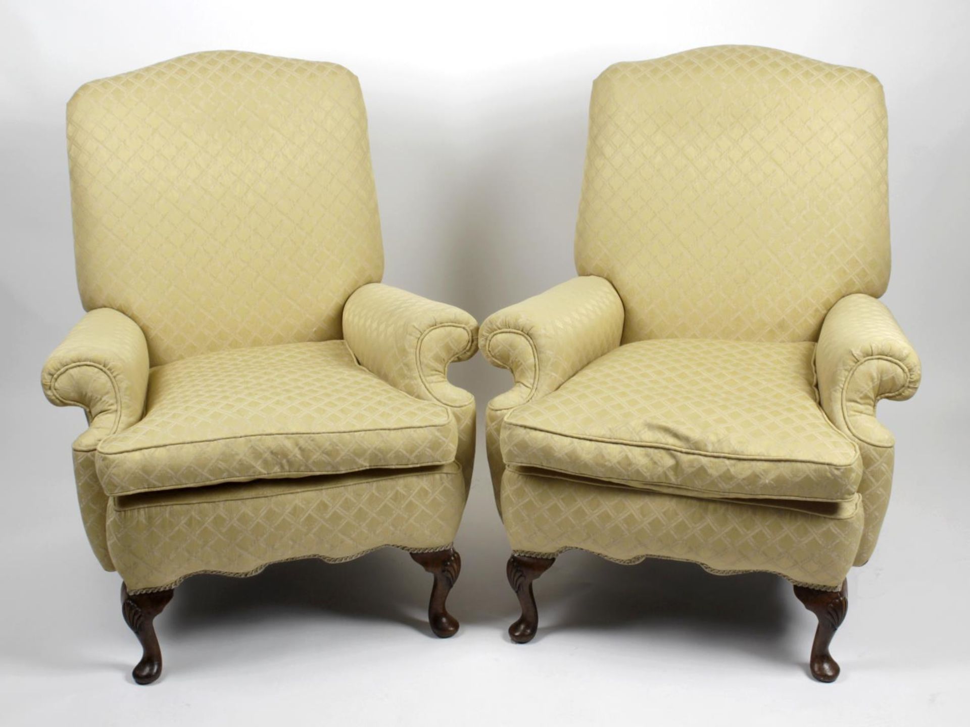 A pair of yellow upholstered armchairs,