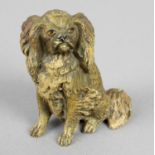 A small cold painted cast bronze study of a seated King Charles Spaniel.