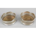 A pair of modern silver mounted bottle coasters,