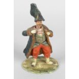 An amusing late 19th century painted carved wooden figure,