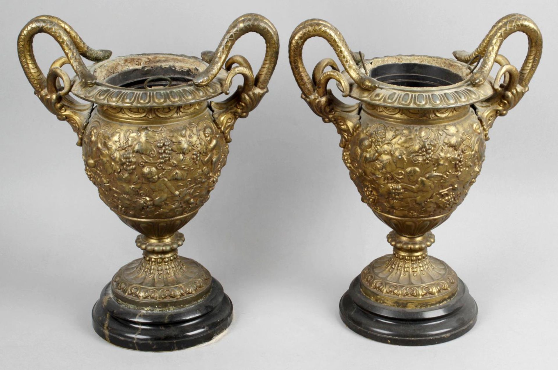 A pair of 19th century cast metal twin handled pedestal vases,