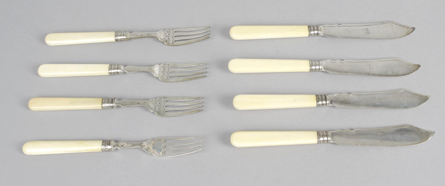A set of six Victorian ivory-handled silver butter knives and side forks,