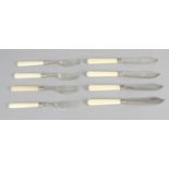 A set of six Victorian ivory-handled silver butter knives and side forks,