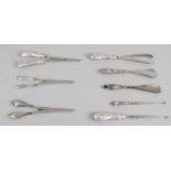 A selection of silver handled button and boot hooks,