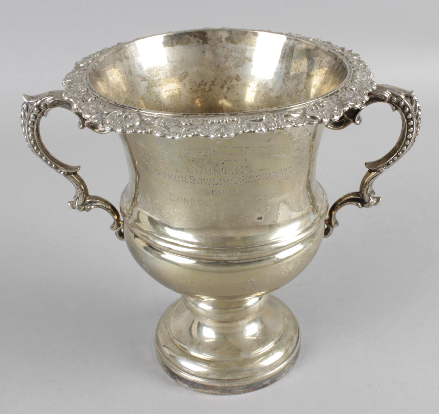 An Edwardian silver small wine cooler with two floral decorated handles,