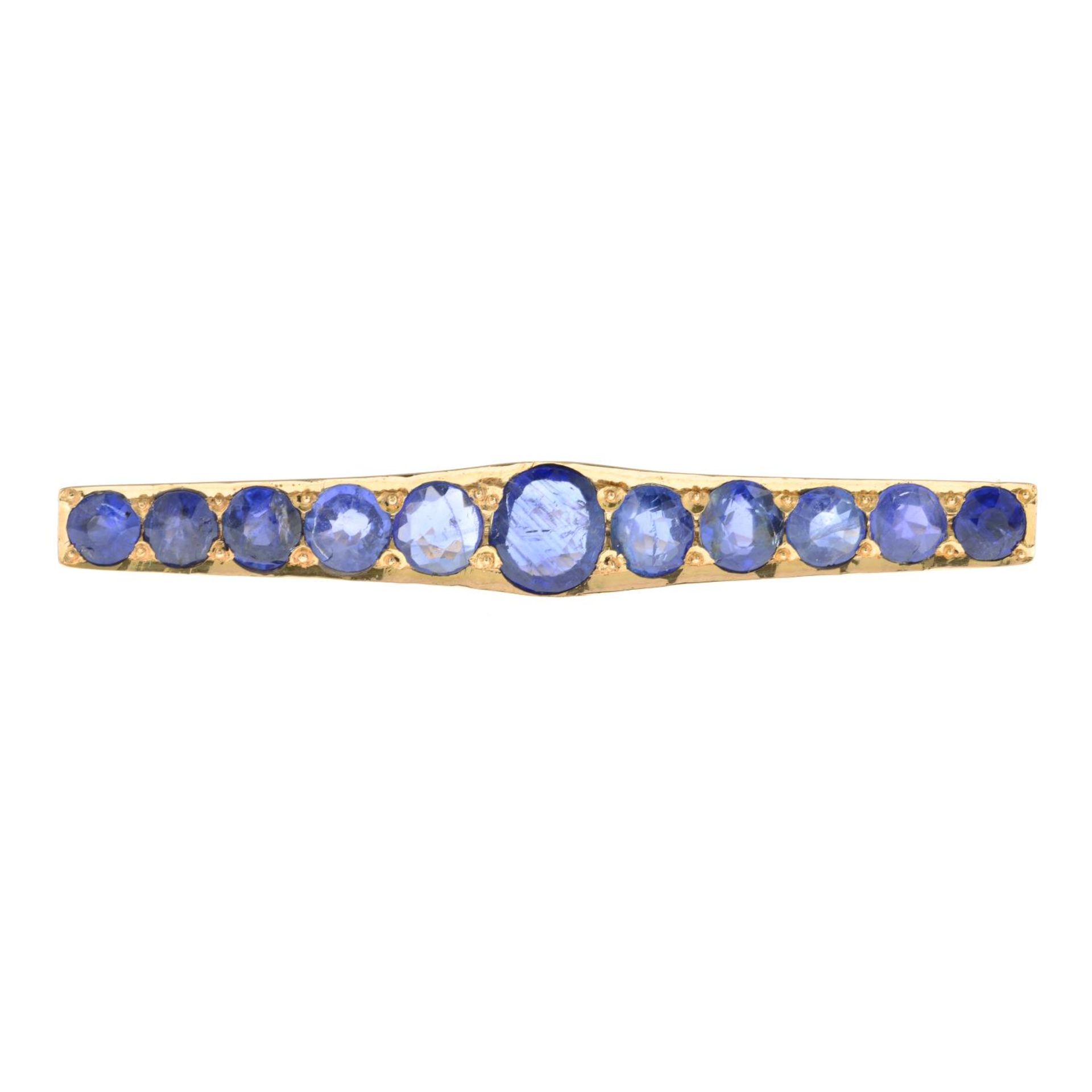 A mid 20th century gold sapphire bar brooch.