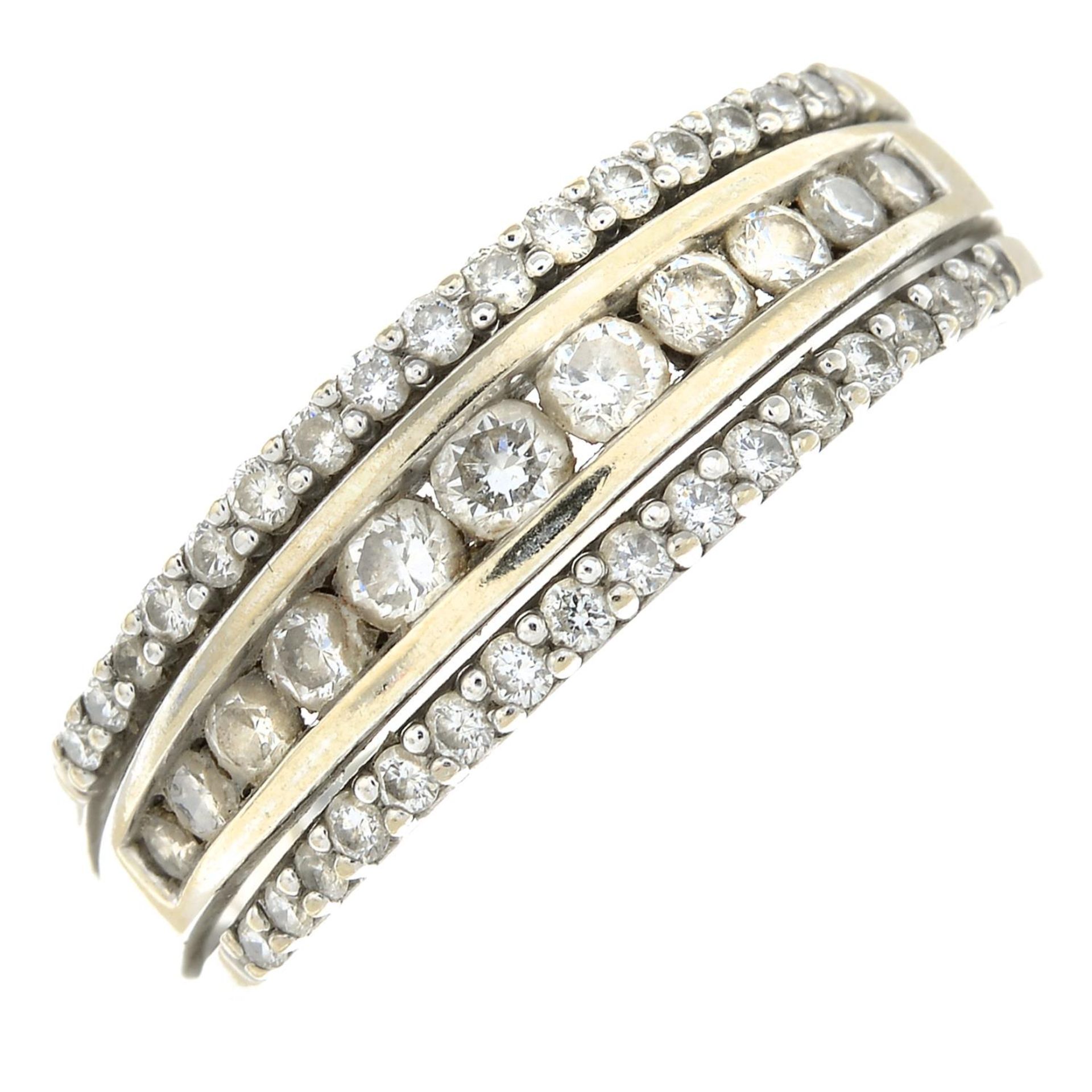 An 18ct gold diamond three-row band ring.Estimated total diamond weight 0.60ct.Hallmarks for