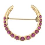 A ruby crescent brooch.Length 2.9cms.