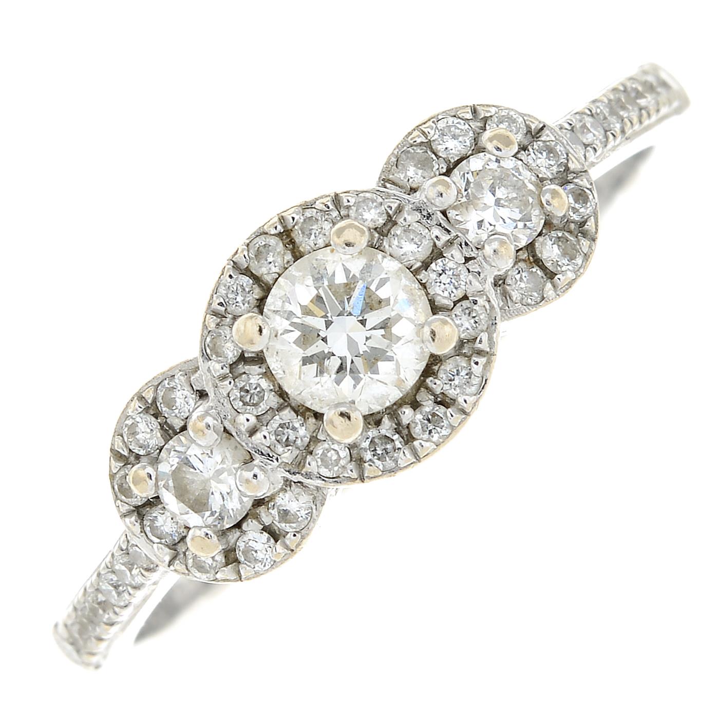 An 18ct gold diamond graduated triple cluster ring.Total diamond weight 0.50ct,