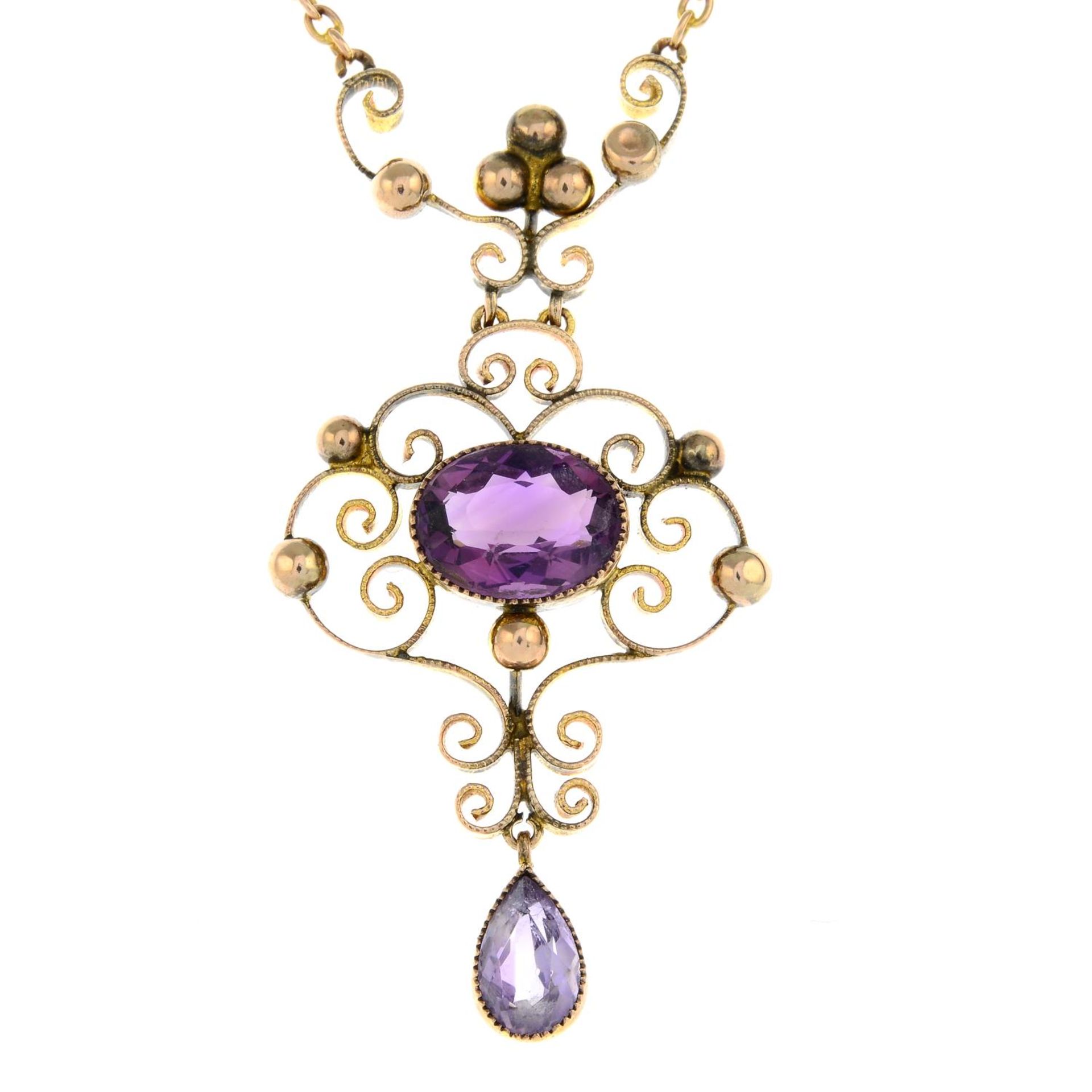 An early 20th century gold amethyst pendant, on an integral chain.Length of pendant drop 4.5cms.