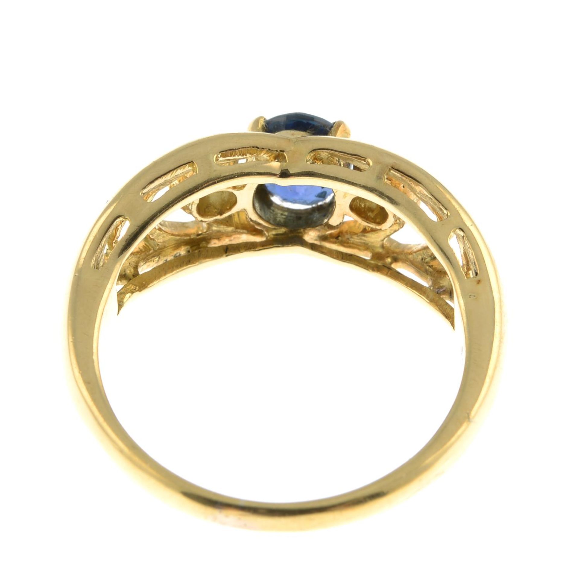 A sapphire and diamond three-stone ring.Estimated total diamond weight 0.10ct.Stamped 18.Ring size - Image 2 of 3