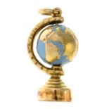 A 9ct gold and enamel charm, designed to depict a globe.Hallmarks for 9ct gold.