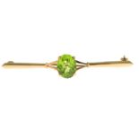 A 1970s 9ct gold peridot bar brooch.Hallmarks for Birmingham, 1977.