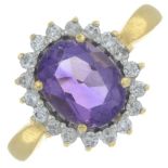 An 18ct gold amethyst and diamond cluster ring.Total diamond weight 0.25ct, stamped to band.