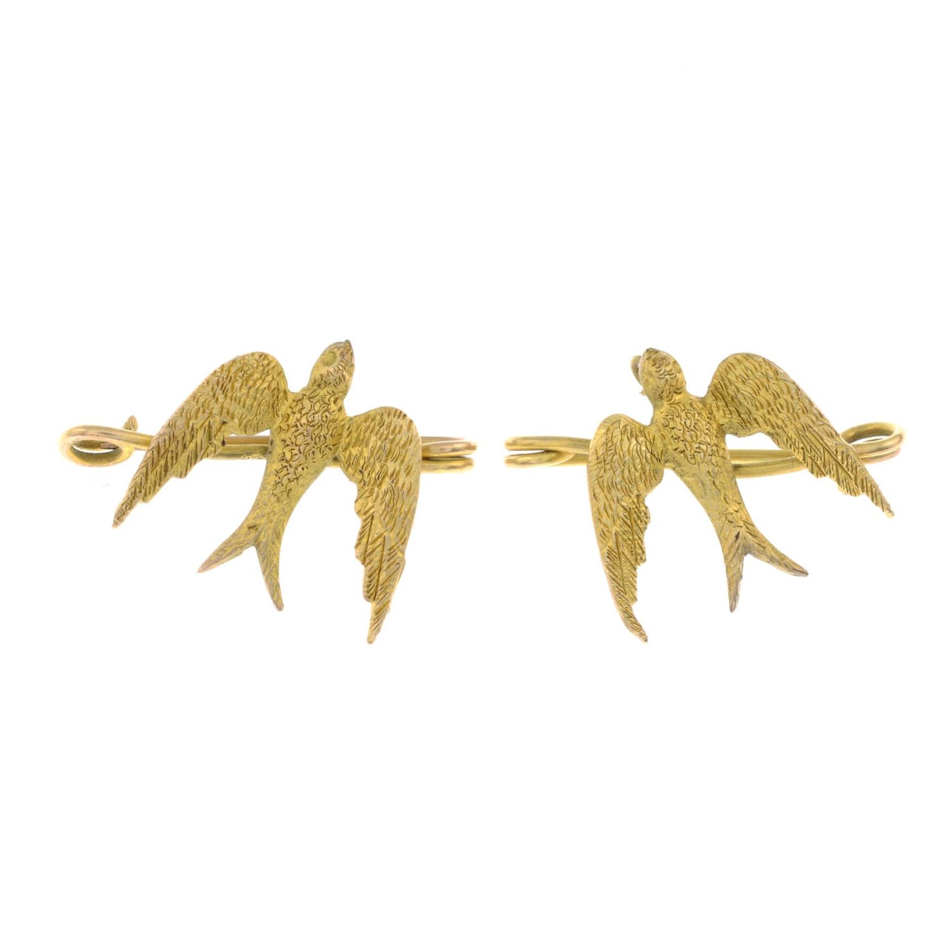 Two swallow brooches.