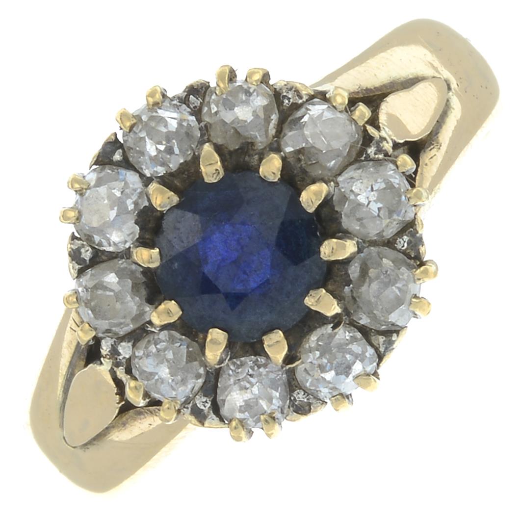A sapphire and diamond cluster ring.Estimated total diamond weight 0.70ct.