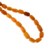An amber single-strand necklace.Amber beads measuring 15 to 12mms, 51.9gms.