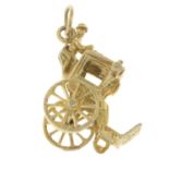 A 9ct gold charm, depicting a carriage.Hallmarks for 9ct gold.