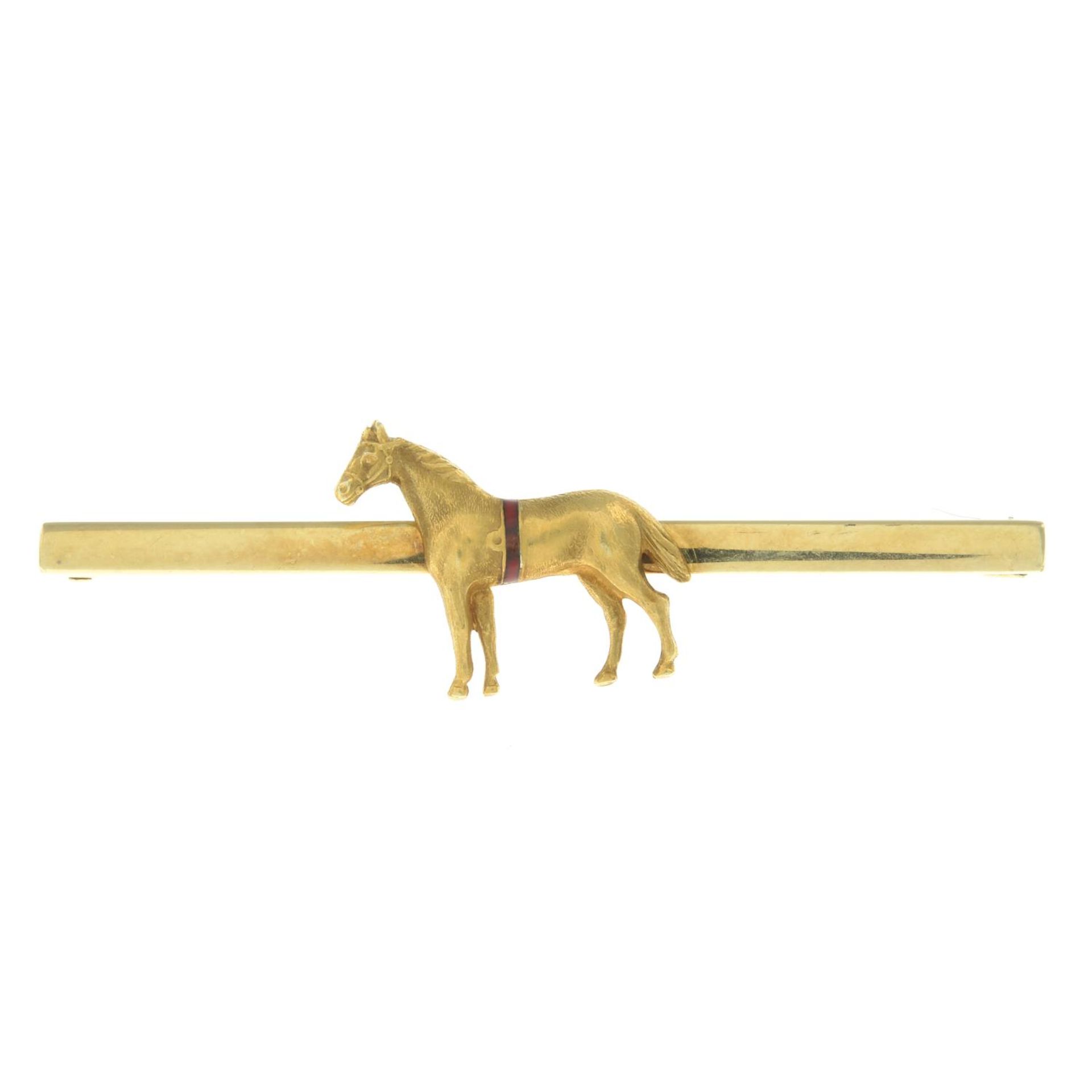 An early 20th century horse brooch with enamel detail.Clasp stamped 14.Length 5.2cms.