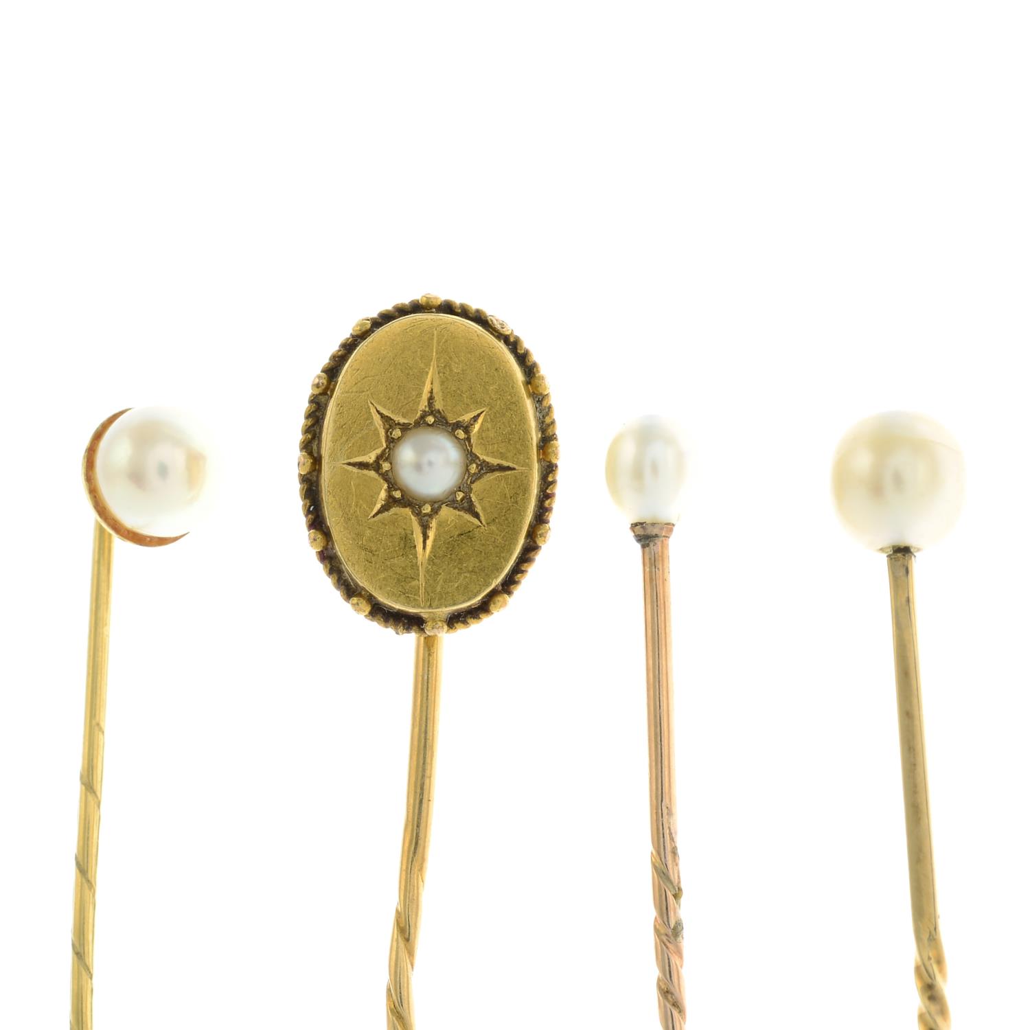 Three cultured pearl stickpins and a split pearl stickpin.