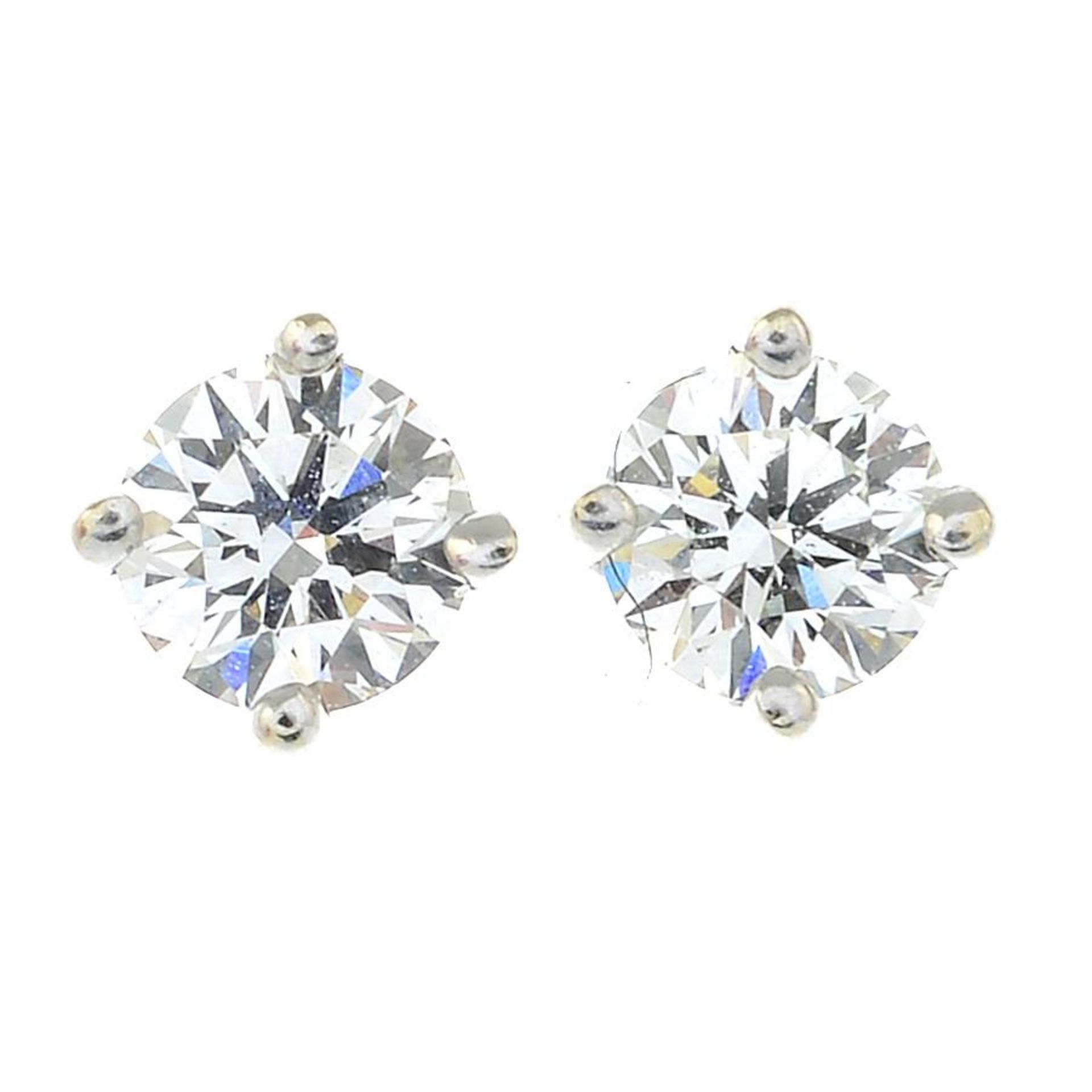 A pair of diamond stub earrings.Estimated total diamond weight 0.40ct, H-I colour, VS clarity.