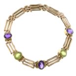 An early 20th century gate-link bracelet, with amethyst and peridot spacers.Stamped 9CT.