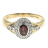 A 14ct gold garnet and diamond ring.Total diamond weight 0.20ct, stamped to band.