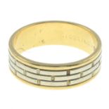 An 18ct gold bi-colour ring, with engraved motif.Hallmarks for 18ct gold.