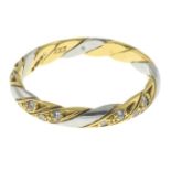 An 18ct gold diamond bi-colour band ring.Estimated total diamond weight 0.15ct.Hallmarks for