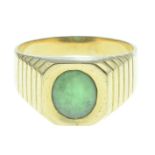 An oval jade cabochon signet ring.Stamped 750.Ring size X.