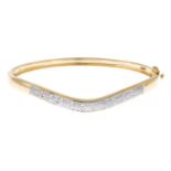 A 9ct gold diamond bangle.Total diamond weight 0.10ct, stamped to mount.