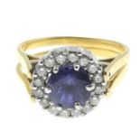 A tanzanite and diamond cluster swivel ring.Estimated total diamond weight 0.55cts.Stamped 750.Ring