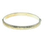 A 9ct gold hinged bangle.Hallmarks for 9ct gold.