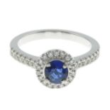 A sapphire and diamond cluster ring.Total diamond weight 0.31ct,