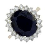 A sapphire and diamond cluster ring.Estimated total diamond weight 0.60ct.