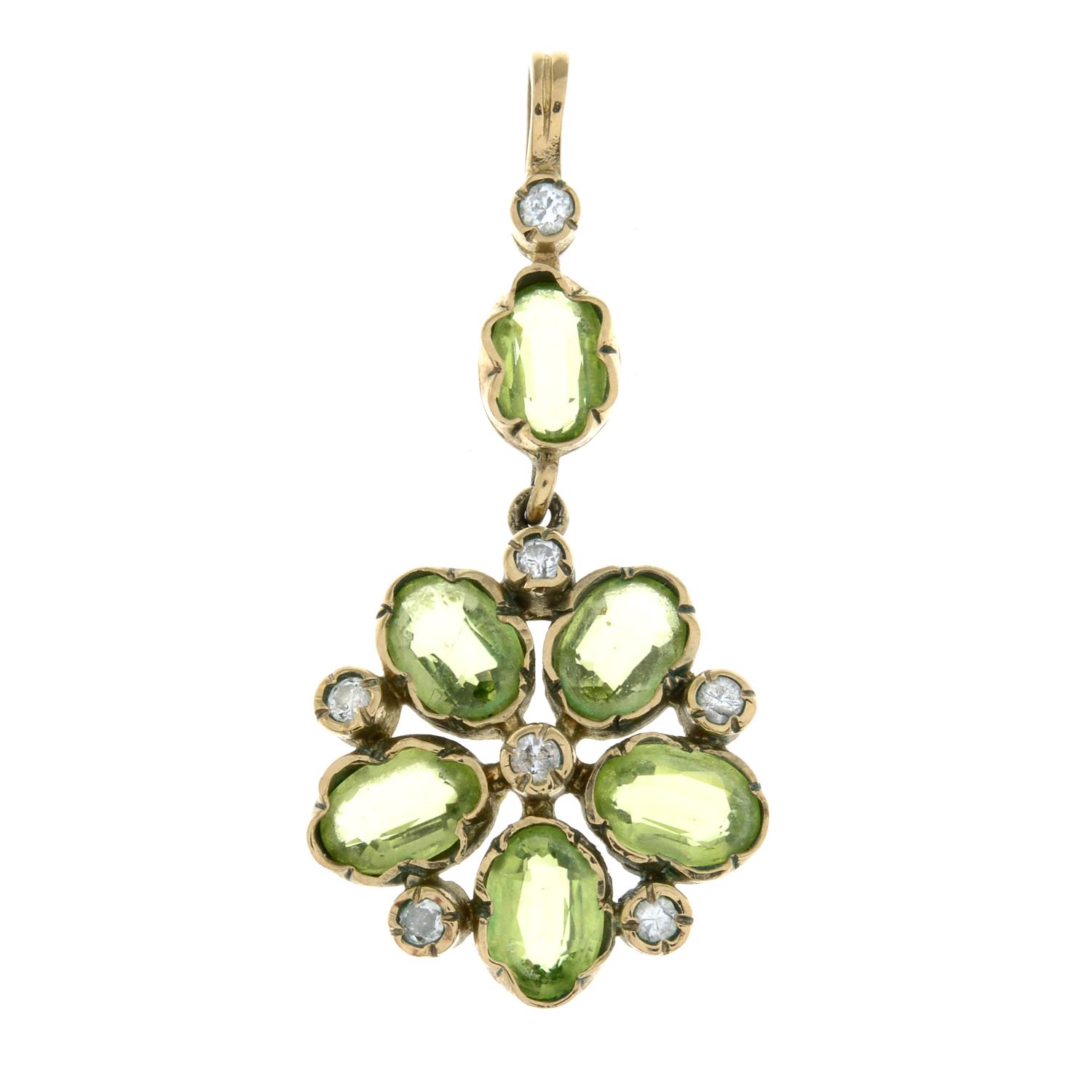 A gold peridot and diamond cluster pendant.