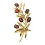 A 9ct gold garnet floral spray brooch.Hallmarks for 9ct gold.