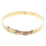 A 9ct gold child's bangle with diamond point detail,