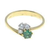 An 18ct gold emerald and diamond dress ring.Total diamond weight 0.12ct.