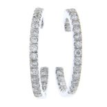 A pair of 9ct gold brilliant-cut diamond hoop earrings.AF.Estimated total diamond weight