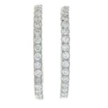 A pair of 9ct gold brilliant-cut diamond hoop earrings.AF.Estimated total diamond weight