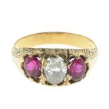 A diamond and synthetic ruby three-stone ring.Estimated diamond weight 0.50ct,