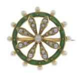An early 20th century gold split and seed pearl and green enamel brooch.Diameter 2.6cms.