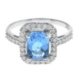 A blue topaz and diamond cluster ring.Estimated total diamond weight 0.40ct.