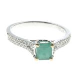 An emerald and diamond dress ring.Total diamond weight 0.23ct,