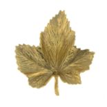 A 1970s 9ct gold brooch, depicting a textured maple leaf.Hallmarks for London, 1970.