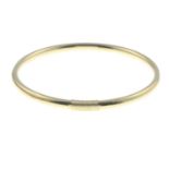 A 9ct gold bangle, with grooved accent.Hallmarks for 9ct gold.