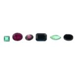 A selection of vari-shape emeralds, rubies, sapphires, and further gemstones.