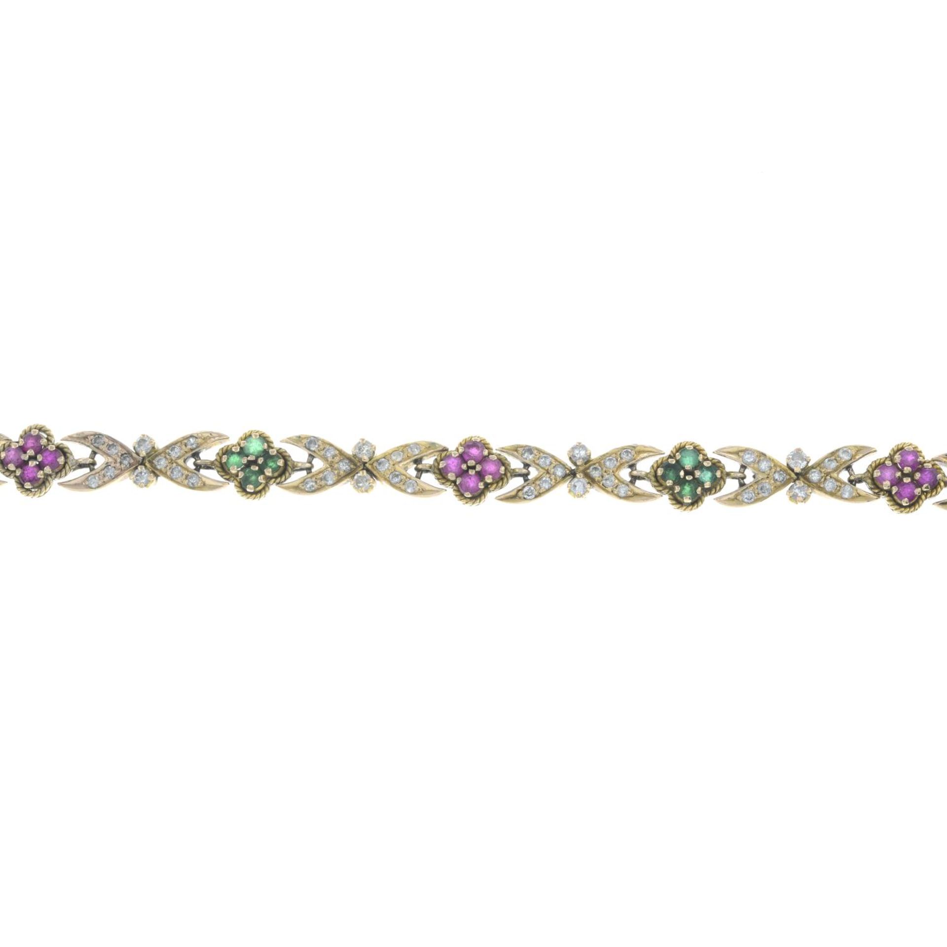 A brilliant-cut diamond and gem-set bracelet.Gems include emerald and synthetic ruby.Estimated