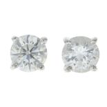 A pair of fracture-filled diamond stud earrings.Estimated total diamond weight 0.90ct.
